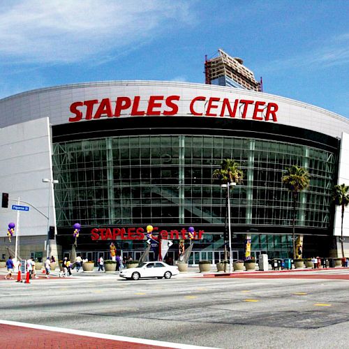 This is an image of Staples Center, a well-known arena in Los Angeles, California. The facade displays the venue's name in large red letters.